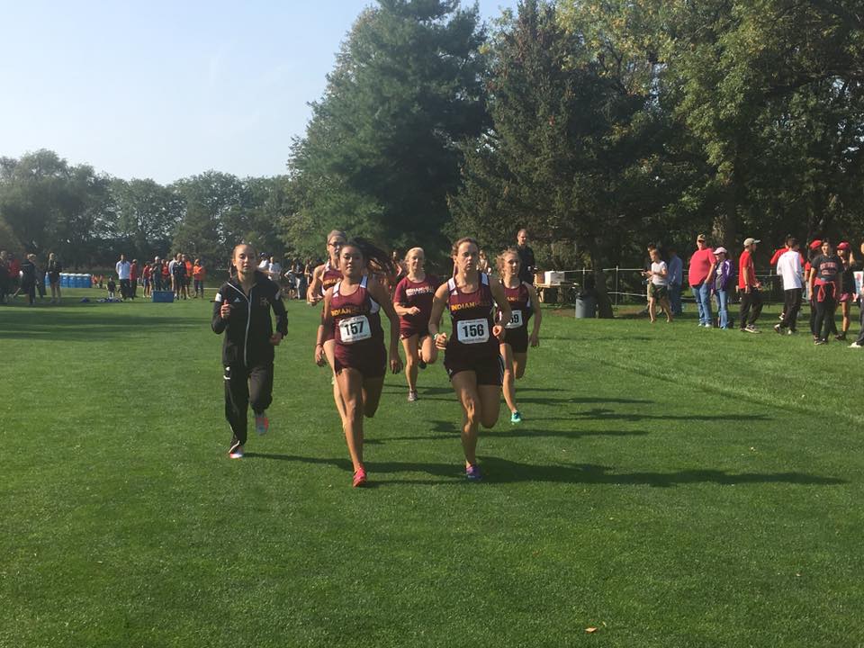 Women's Cross Country runners running to the finish line.